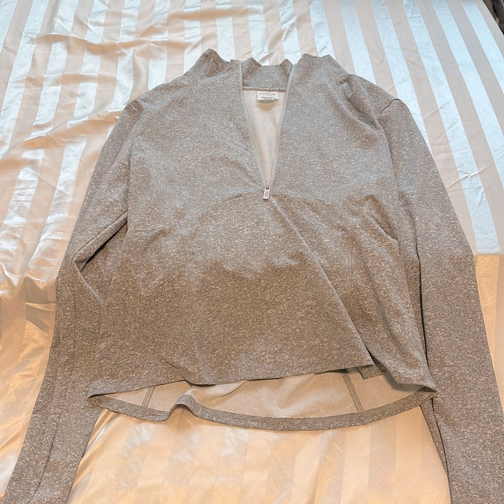 Light gray athletic pull over. Fits true to size but can fit oversized for a S/M